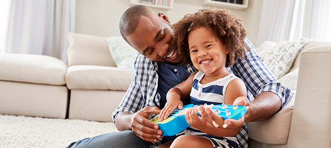 Infants and Children / dad playing with daughter and her toy guitar