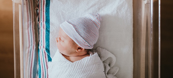 Image of baby laying in bed