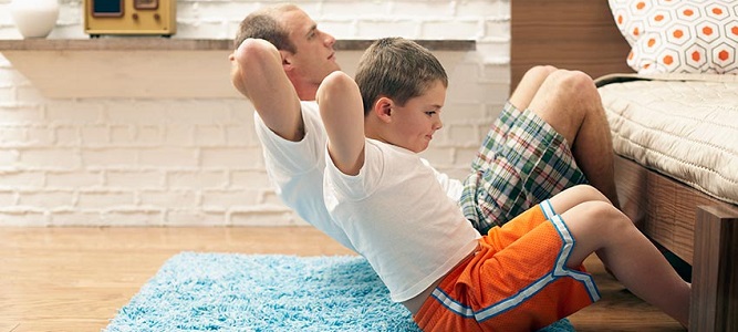 Image of father and son working out