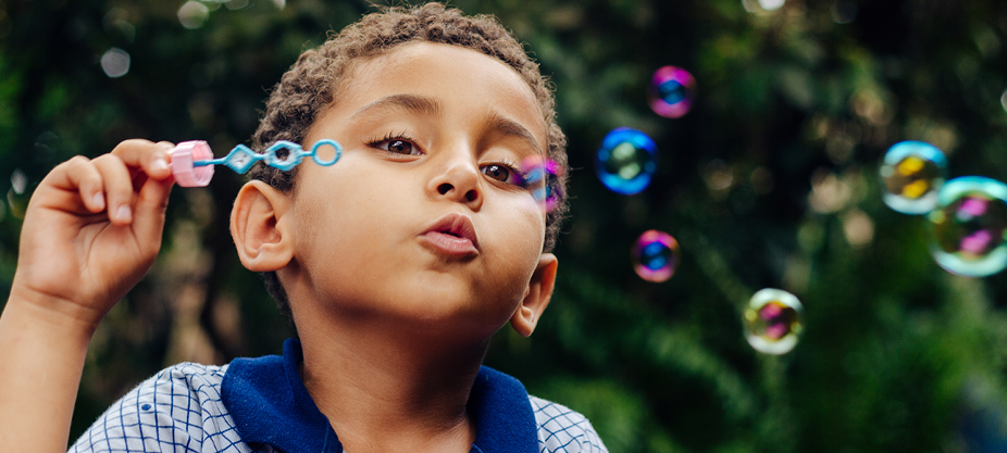 boy blowing bubbles