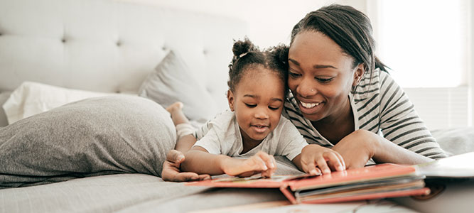 Child Development Center / African American mother and child reading a book together