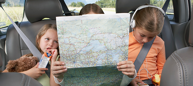 locations and directions / three kids in a car bored and reading a map