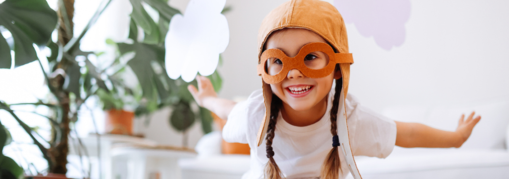 girl playing airplane pilot