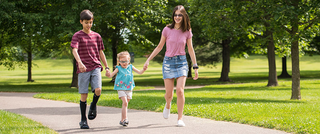 Colton, Chelsie and Caitlin walk through the park
