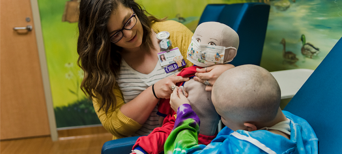 Image of Child Life Specialist playing with child