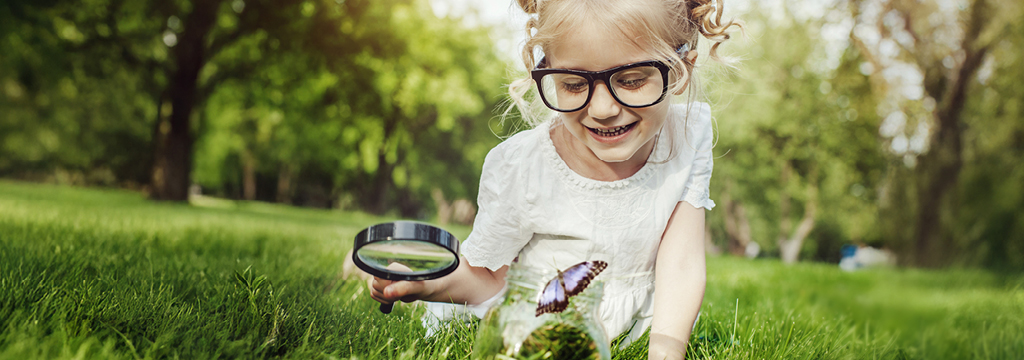 girl looking at butterfly