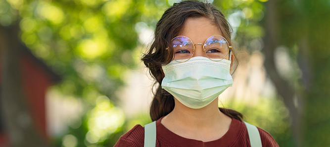 Image of child smiling with mask on