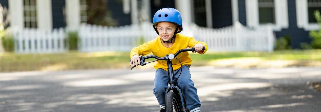 Pediatric Hospital Visit / Boy on a bicycle smiling 